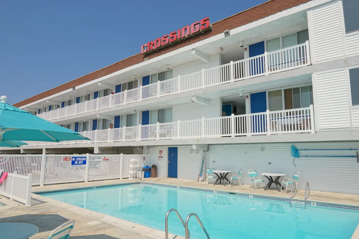 The pool and the three-story building, with the red Crossings sign on the roof